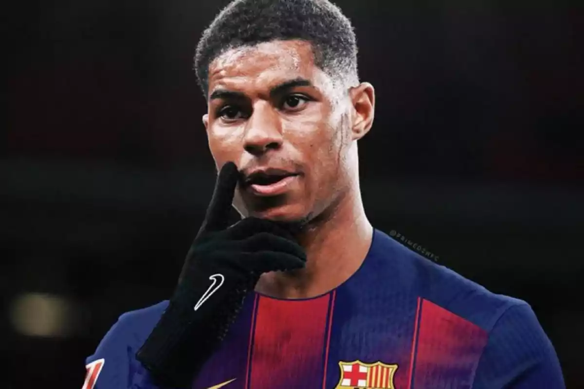 A player in a Barcelona uniform puts his hand to his face while looking straight ahead. A player in a Barcelona uniform puts his hand to his face while looking straight ahead.