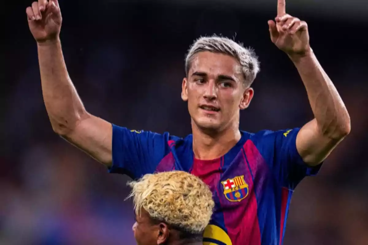 Barcelona player celebrating a goal with arms raised during a match