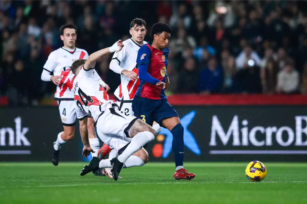 Soccer players compete for the ball in a match.