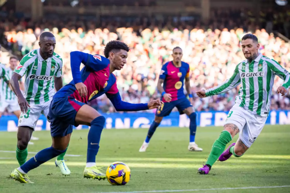 Soccer players from two teams compete for the ball in a match.