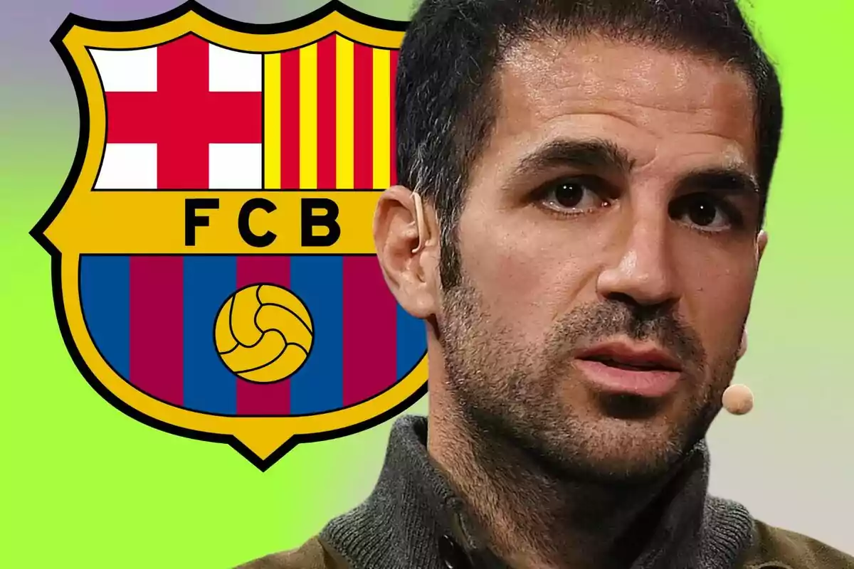 A man with a microphone in his ear in front of the FC Barcelona crest on a green background.