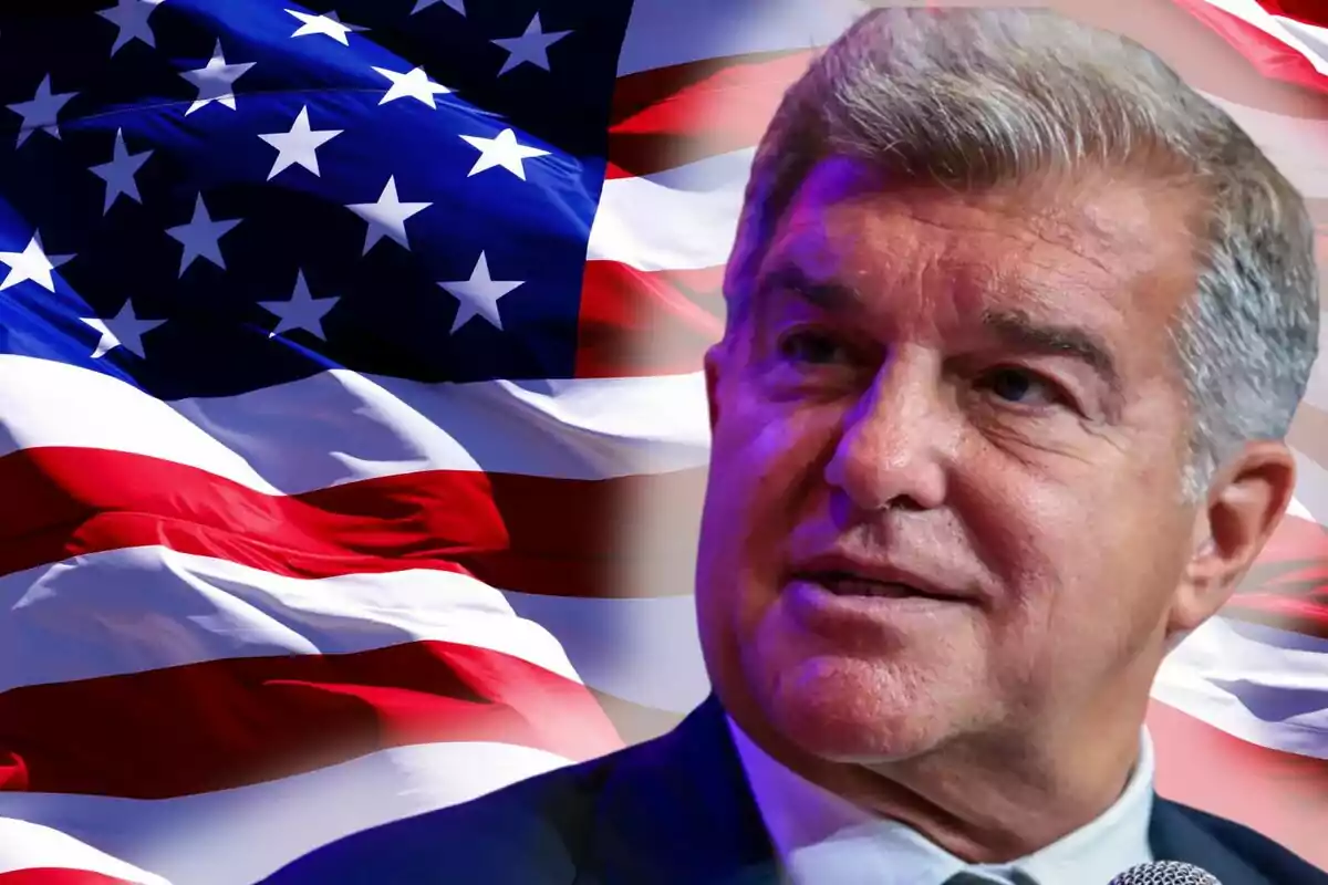 A gray-haired man in front of a waving United States flag.