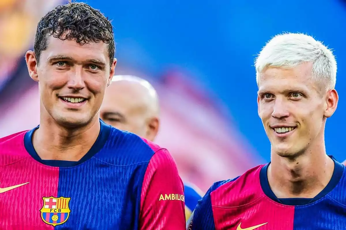 Dos jugadores del FC Barcelona sonríen mientras usan el uniforme del equipo.