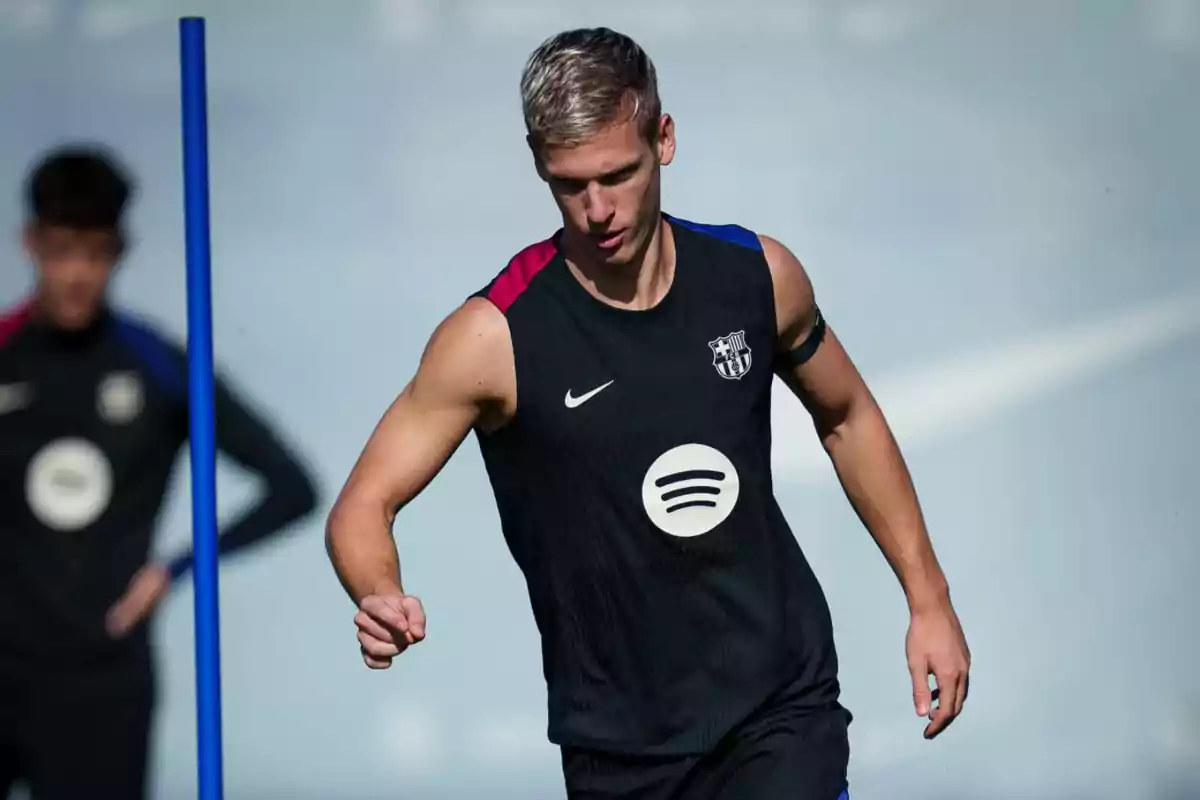 A soccer player training in a sleeveless FC Barcelona jersey.