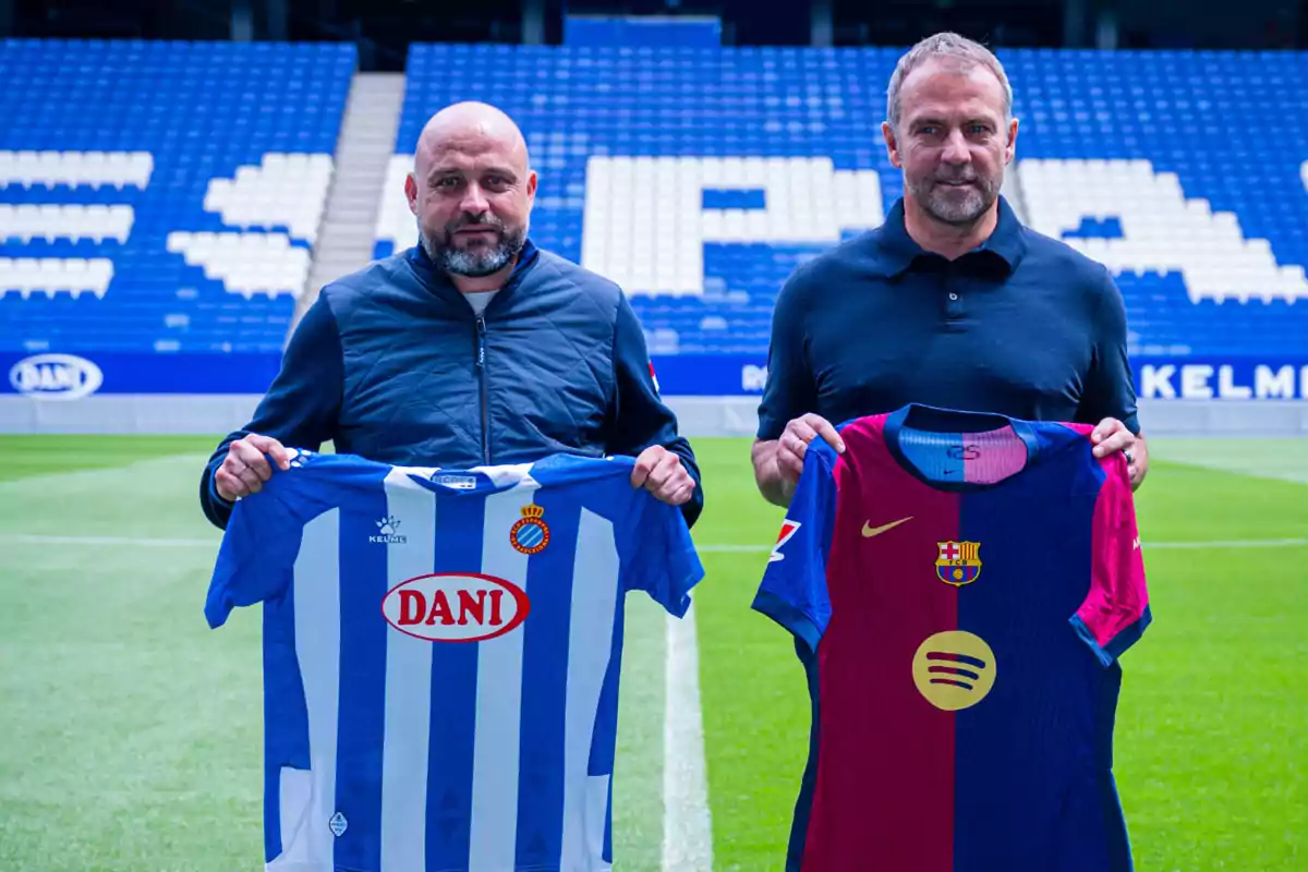 Dos hombres sostienen camisetas de fútbol de los equipos Espanyol y Barcelona en un estadio. Dos hombres sostienen camisetas de fútbol de los equipos Espanyol y Barcelona en un estadio.