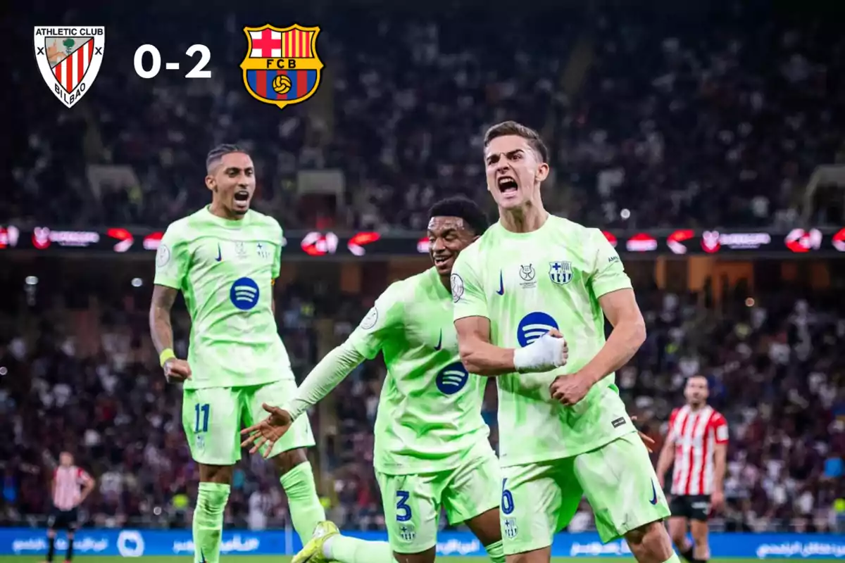 Barcelona players celebrate a goal in a match against Athletic Club with the score showing 0-2 in favor of Barcelona.