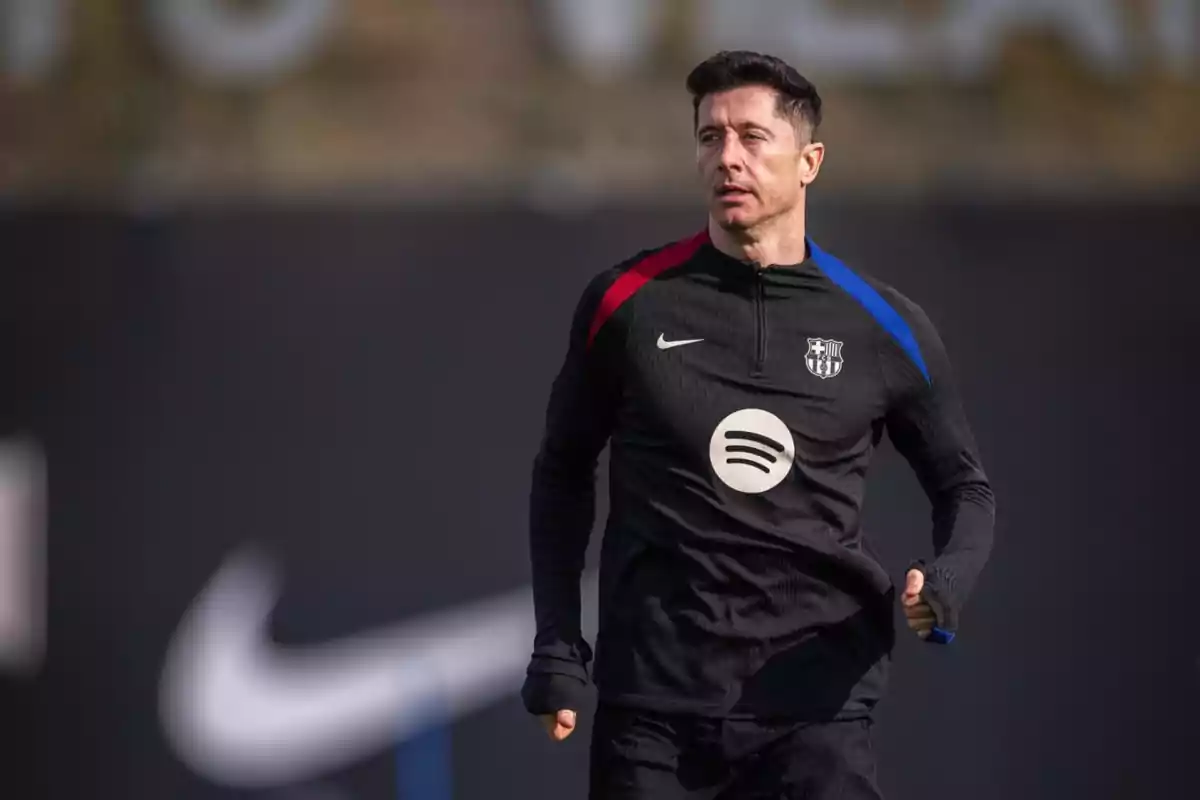 A soccer player training in black sportswear featuring Nike, Spotify and team logos.