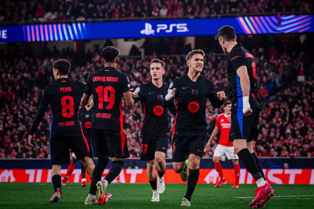 Football players celebrating a goal in a stadium full of spectators. Football players celebrating a goal in a stadium full of spectators.