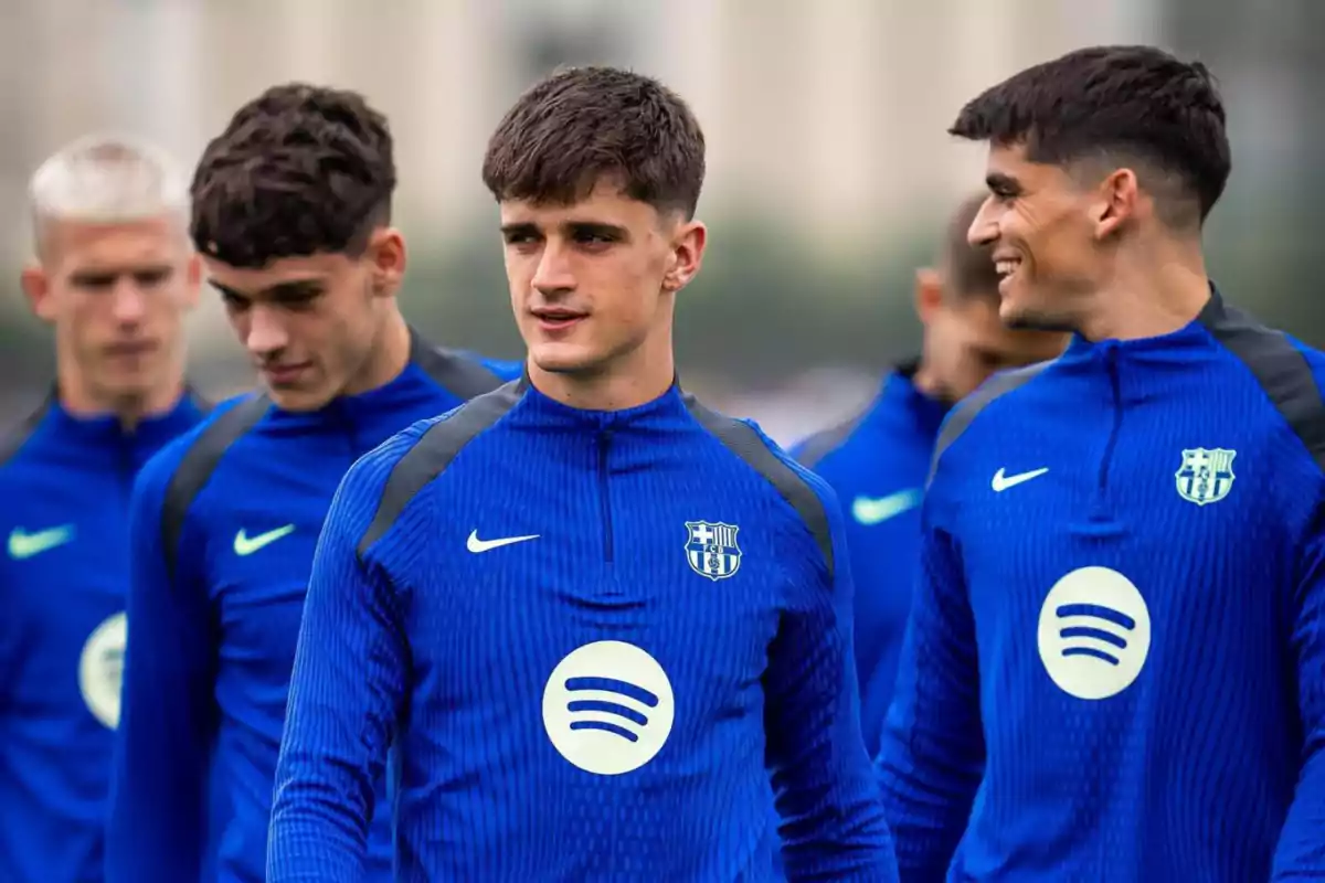 A group of young footballers in blue FC Barcelona uniforms during a training session.