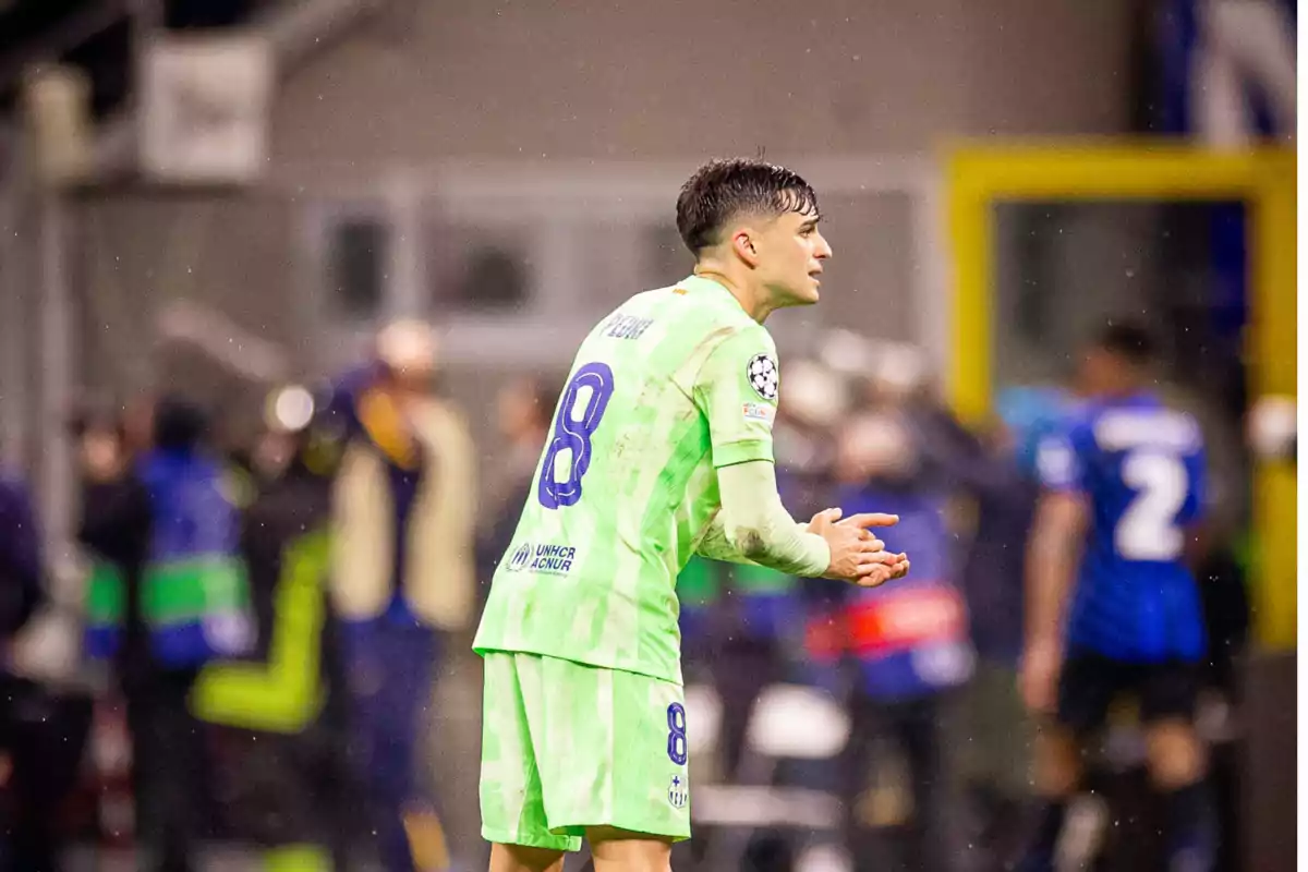 Soccer player in a green uniform on the field during a match. Soccer player in a green uniform on the field during a match.