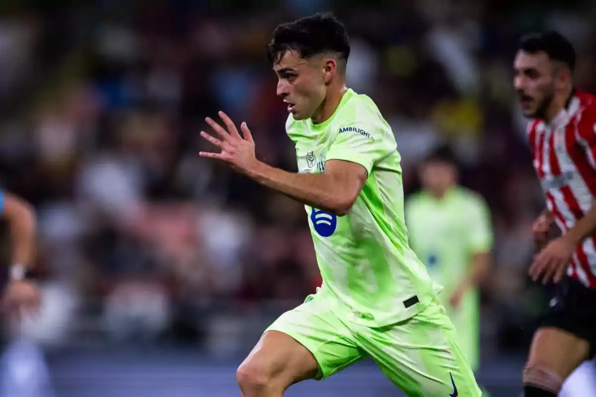 A soccer player running on the field during a game wearing a light green uniform.